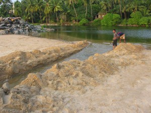 Draining the lagoon at Kannur beach